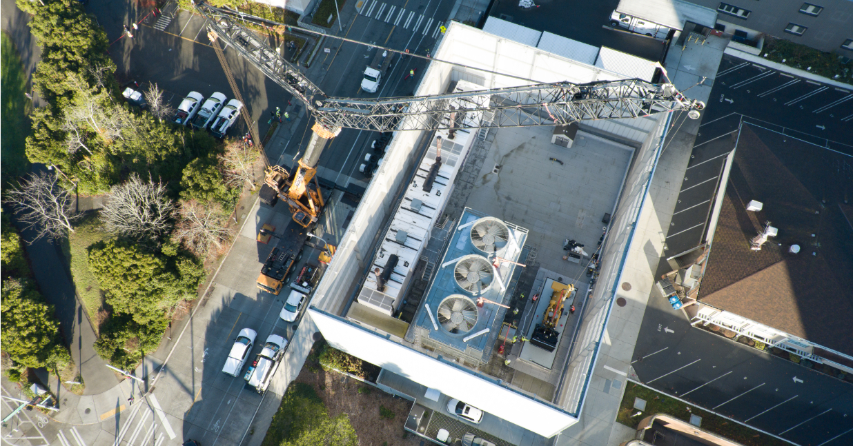 Sourcewell project in Seattle Washington. Crane placing large genset on top of a building. 